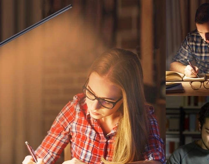 A Napatek desk lamp near someone writing.