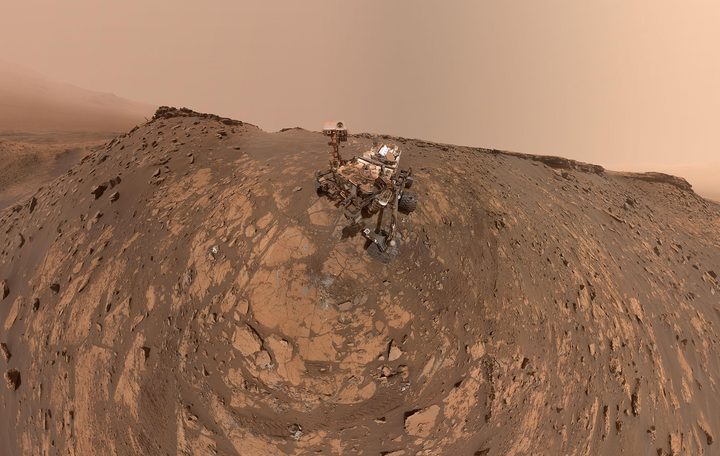 This selfie was taken by NASA's Curiosity Mars rover on Feb. 26, 2020 (the 2,687th Martian day, or sol, of the mission). The crumbling rock layer at the top of the image is "the Greenheugh Pediment," which Curiosity climbed soon after taking the image.