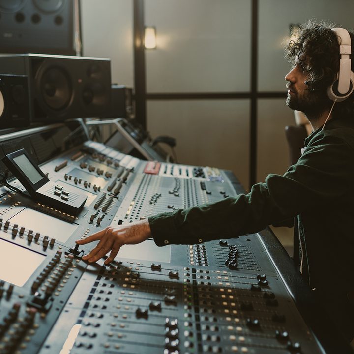 Sound engineer at a studio mixing board.