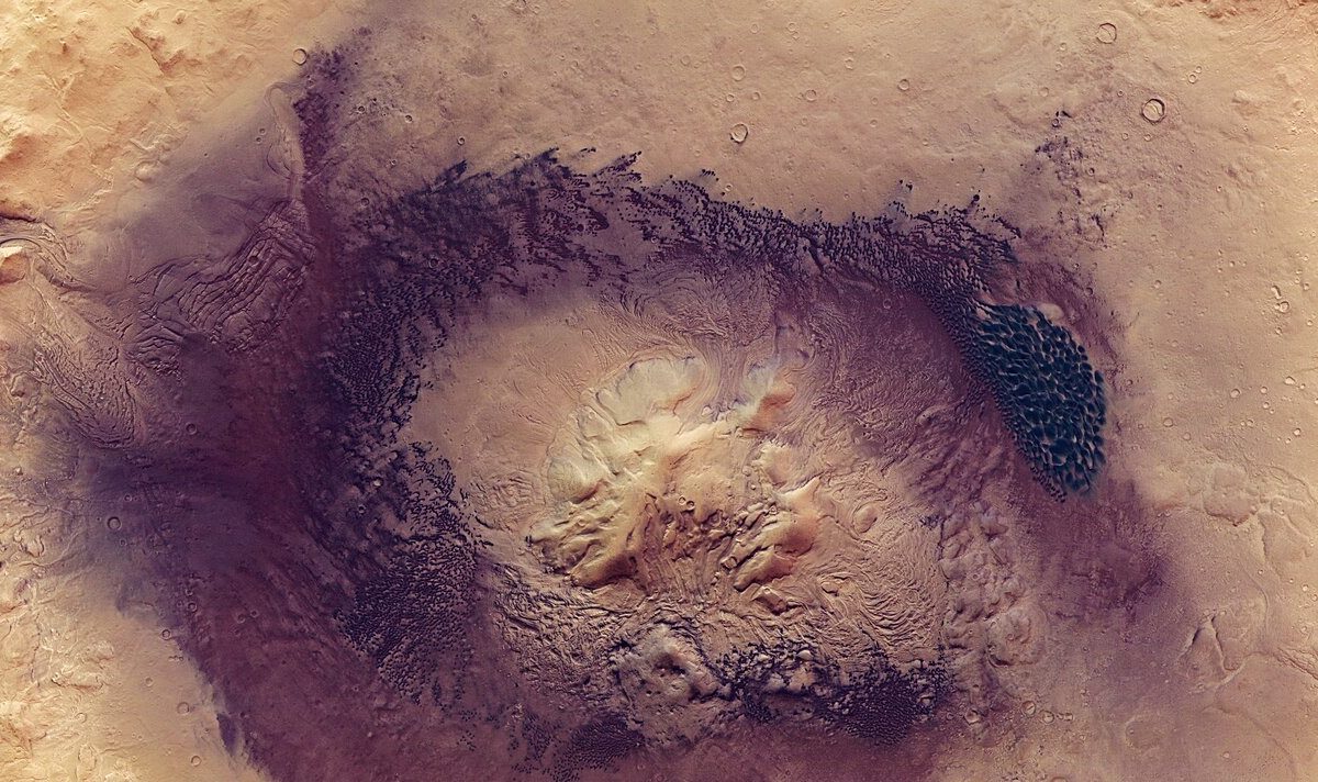 Known for its wide swathes of rippling, textured, gently sloping dunes, Mars’ Terra Sabaea region is home to many fascinating geological features – including the prominent Moreux crater, the star of a new image from ESA’s Mars Express.