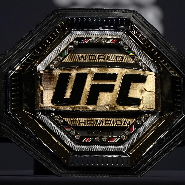 A UFC championship belt sitting on a table.