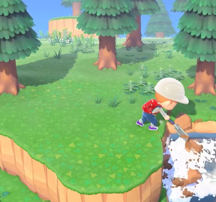 A villager in a hardhat digging out a waterfall.