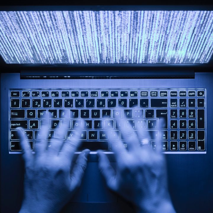 Hands on a laptop.