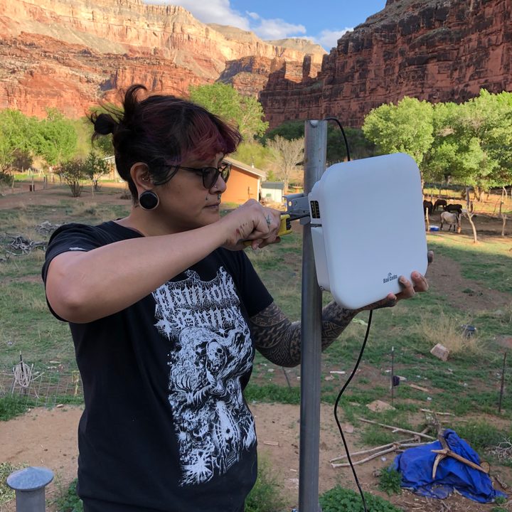 Ophelia Watahomigie-Corliss, a tribal councilwoman in Arizona, installs a hotspot at the bottom of a canyon.