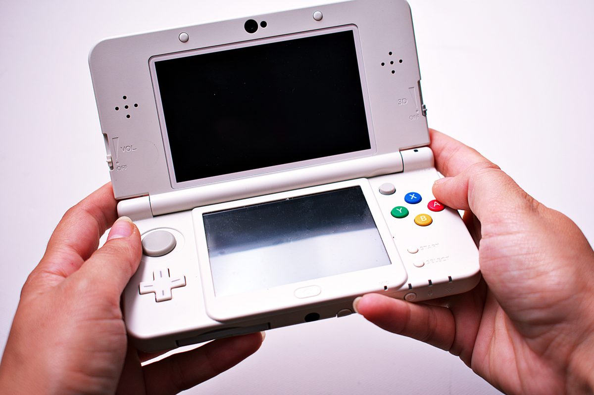 Person holding Nintendo 3DS in hands