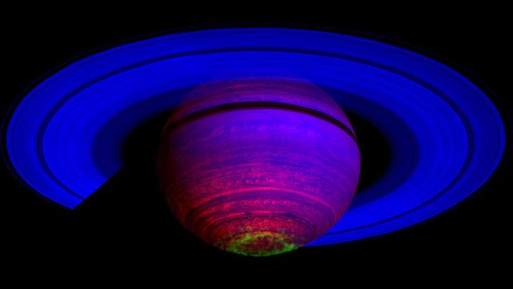 This false-color composite image shows auroras (depicted in green) above the cloud tops of Saturn's south pole. The 65 observations used here were captured by Cassini's visual and infrared mapping spectrometer on Nov. 1, 2008.
