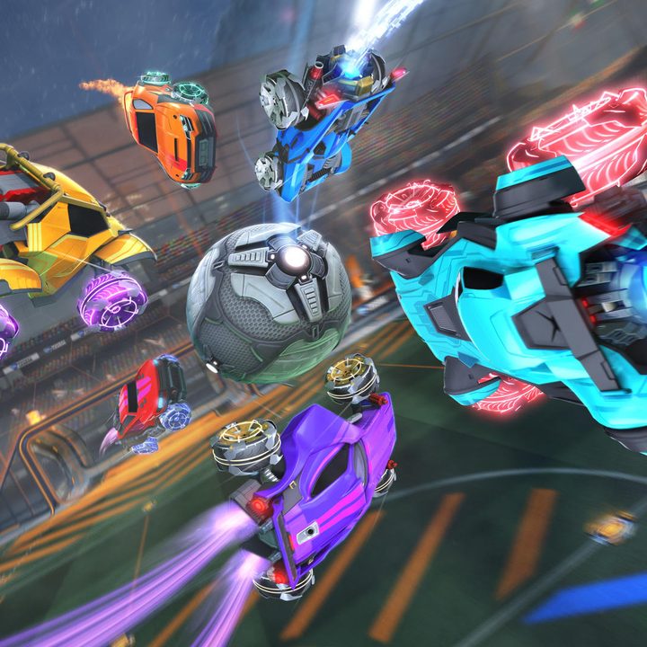 Six cars dive for the ball in a Rocket League match.