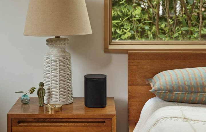 The Sonos One on a bedside table.