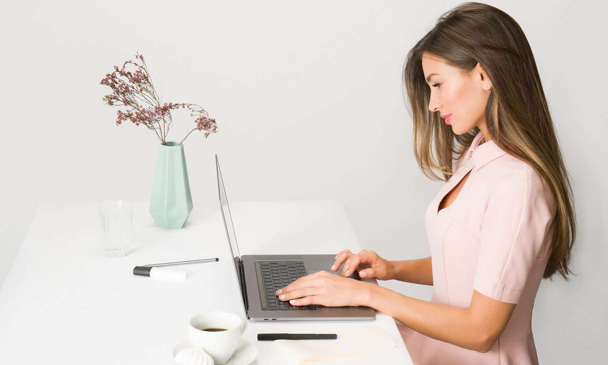 Stock photo of woman using laptop at desk