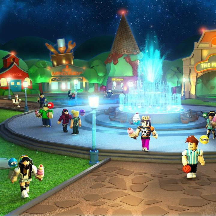 Characters hang out by a fountain in Roblox.