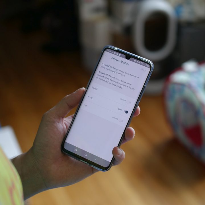 Person enabling privacy shutter using their camera app.