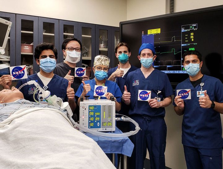 Doctors give a thumbs up after testing a ventilator prototype