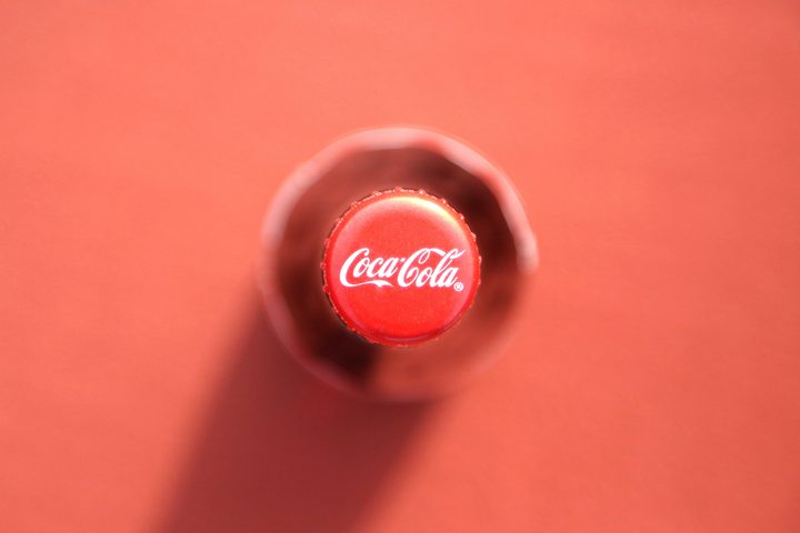 Coke Bottle Cap Red Background