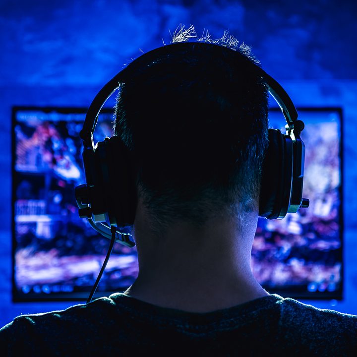A man games on a PC Gaming Monitor with LED Lights.
