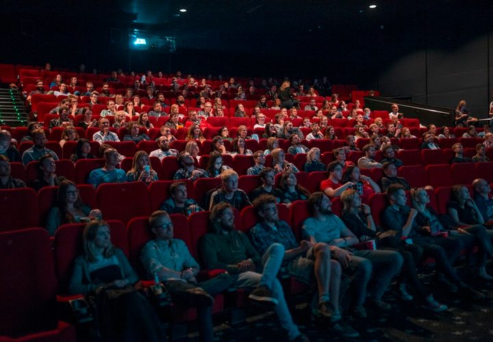 People sit in a movie theater.