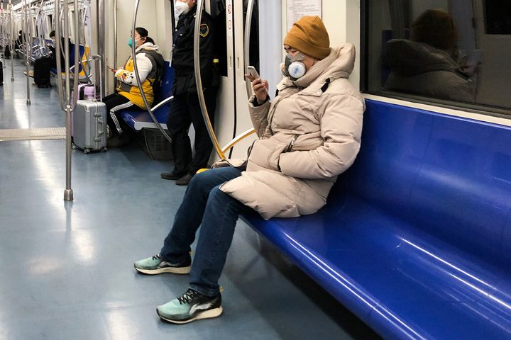 Rider using mask on transit.