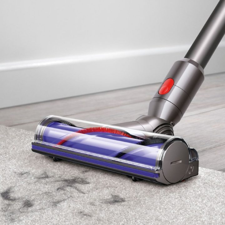 The Dyson V7 Animal cordless vacuum picking up dirt from the floor.