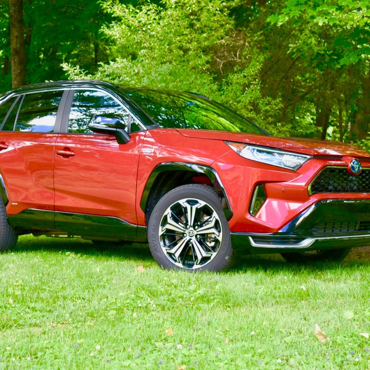 A 2021 Toyota RAV4 Prime in a park-like setting.