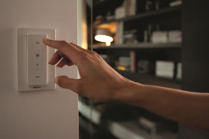 A person using a smart light switch.