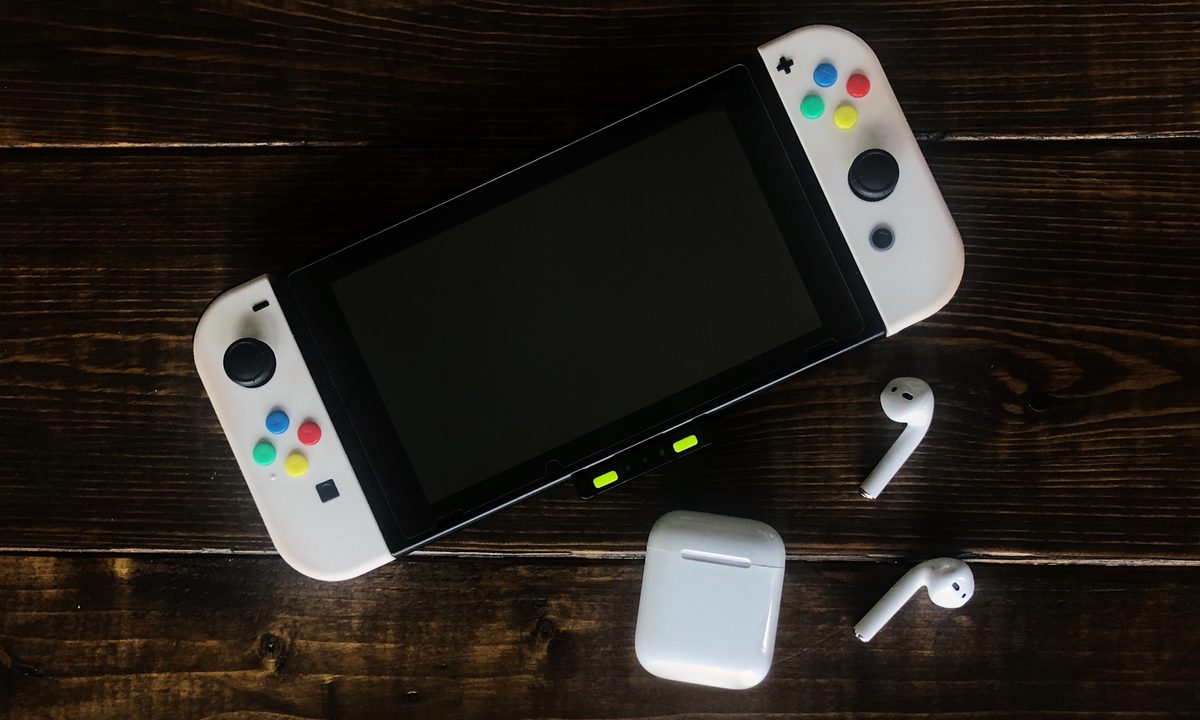 A Nintendo Switch with Apple AirPods