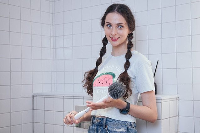 Female holding Good Papa toilet brush