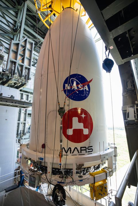 The payload fairing, or nose cone, containing NASA's Mars 2020 Perseverance rover is maneuvered into place atop the Atlas V rocket that will hurl it toward Mars.
