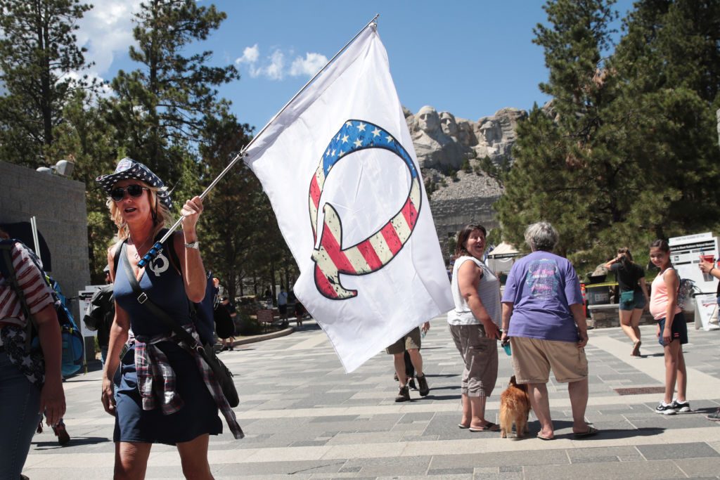 QAnon supporter with Q flag