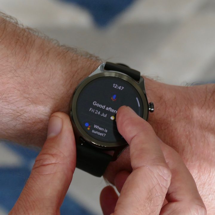 A man engaging with Google Assistant on the TicWatch C2 Plus.
