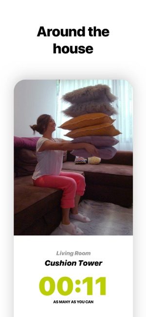 Screenshot of Wakeout app showing a woman exercising by lifting a stack of cushions and text saying Around the house