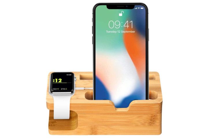 Photo shows an iPhone and Apple Watch in a bamboo docking station