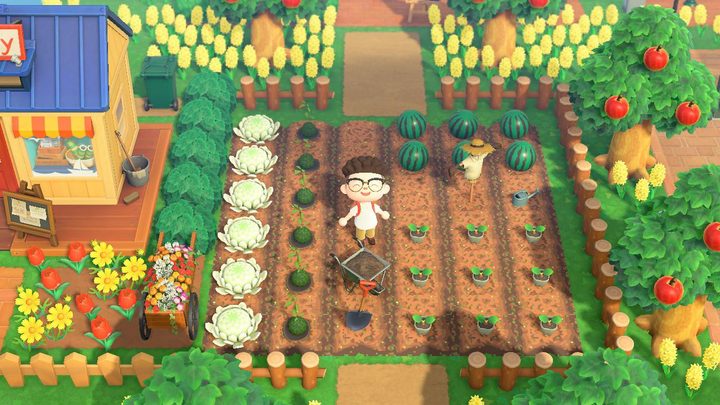A photo of an Animal Crossing character standing and smiling amidst a custon garden full of vegetables, surrounded by trees and flowers