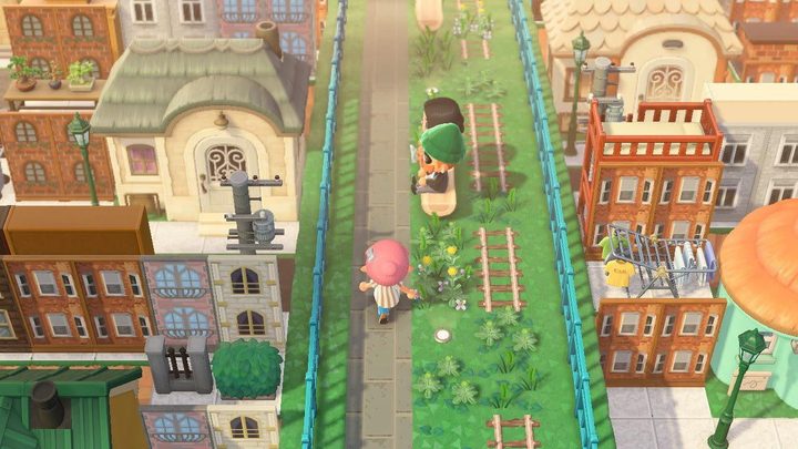 A screenshot of an overgrown bridge overlooking buildings in Animal Crossing: New Horizons