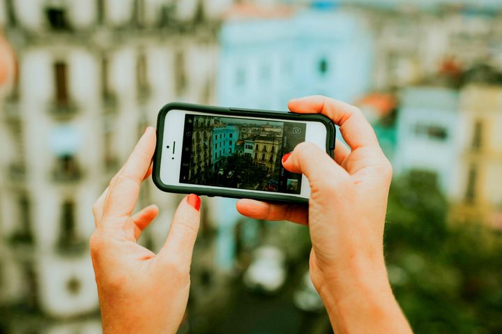 woman holding phone in cuba