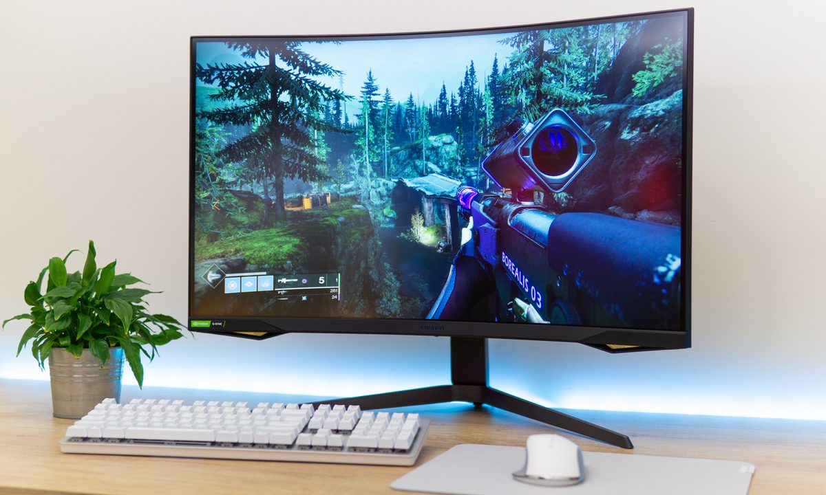 A Samsung Odyssey G7 monitor on a desk.