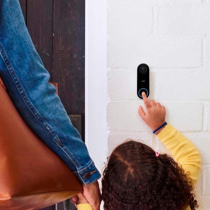 A child pressing the Nest Hello doorbell.