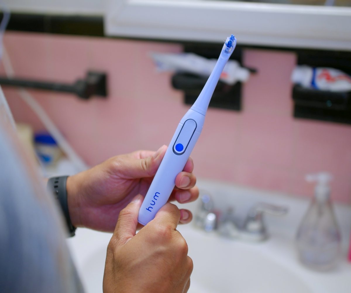 Hum by Colgate Smart Toothbrush in hand