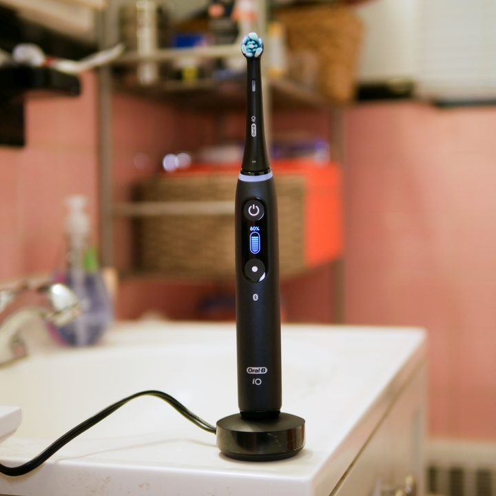 A smart toothbrush improves dental hygiene at home.
