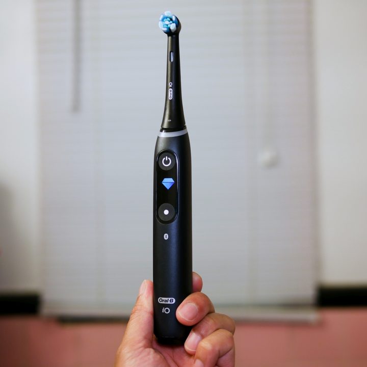The Oral-B iO being held in hand.