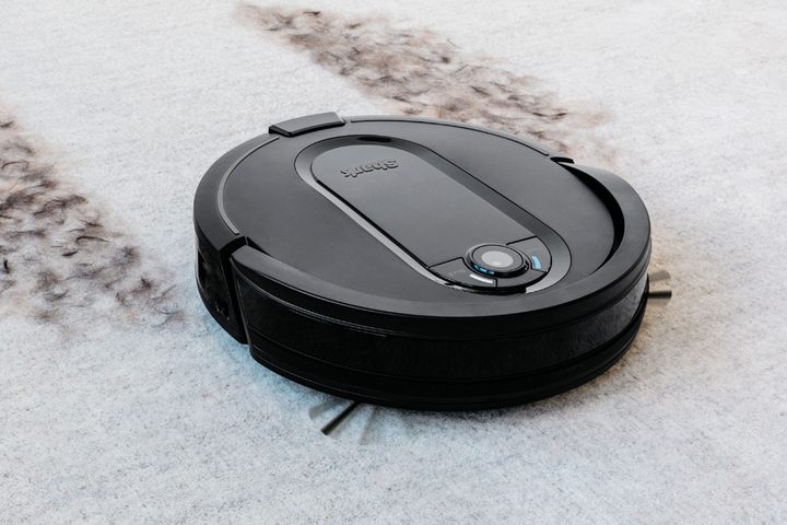 The Shark IQ self-emptying robot vacuum cleaning the floor.