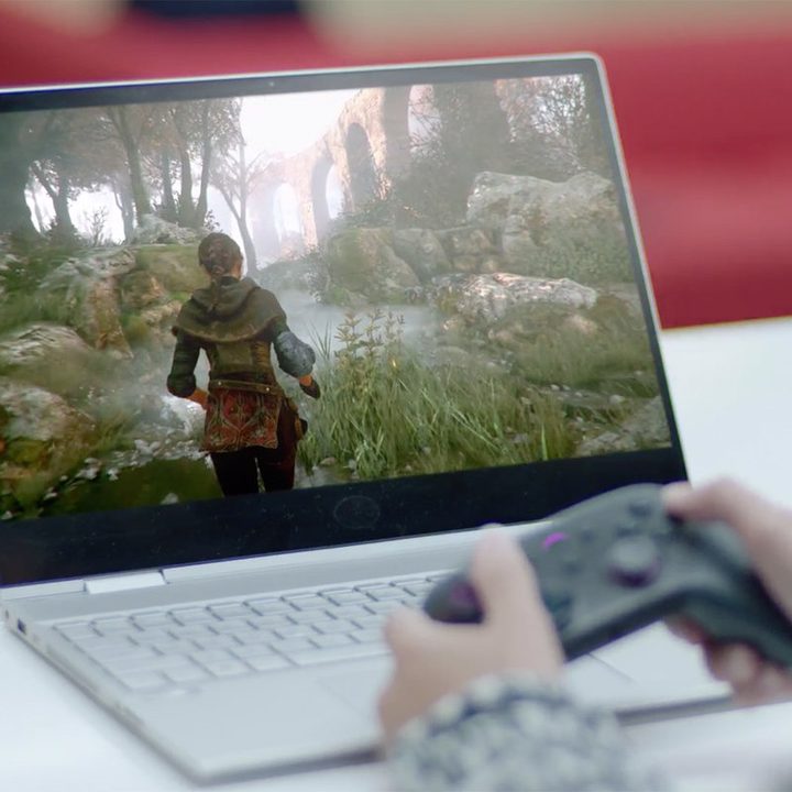 A person plays a game on Amazon Luna on a laptop.