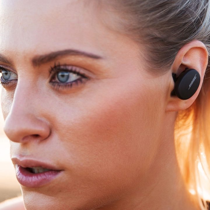 Woman wearing Bose Sport Earbuds.