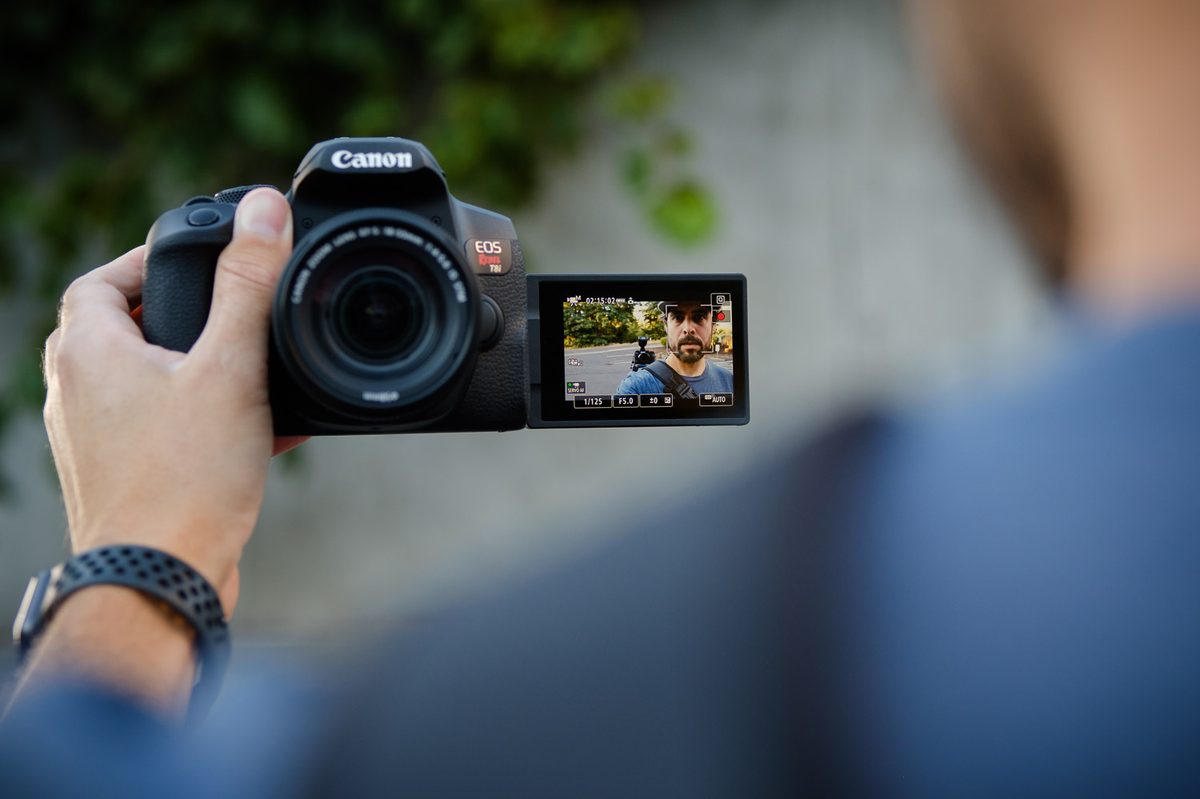 Product photo of Canon EOS Rebel T8i being used in selfie mode.