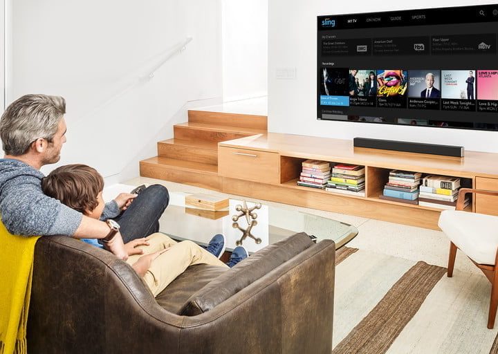 A man watching Sling TV in his living room.