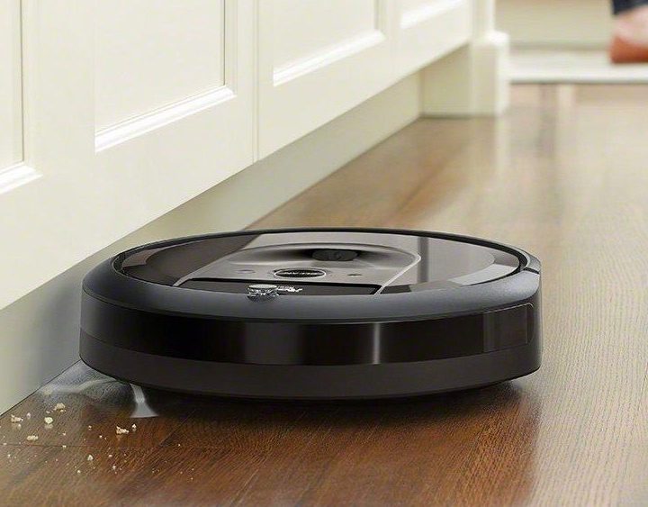 Roomba i7+ cleaning along base of wall.