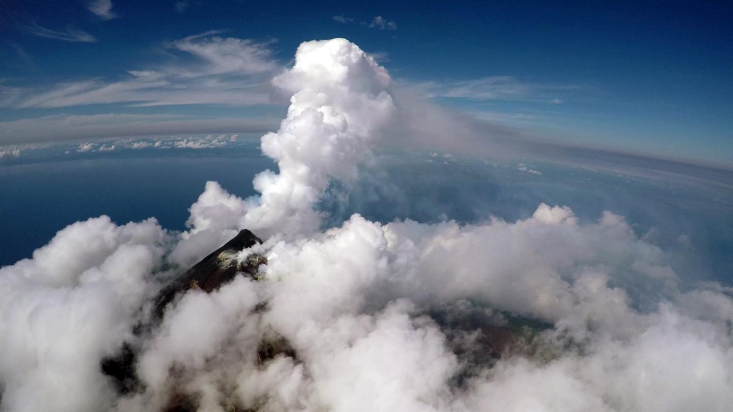 Aerial view of the active vent and gas plume of Manam volcano, Papua New Guinea, from a fixed-wing drone at 2300 m altitude.