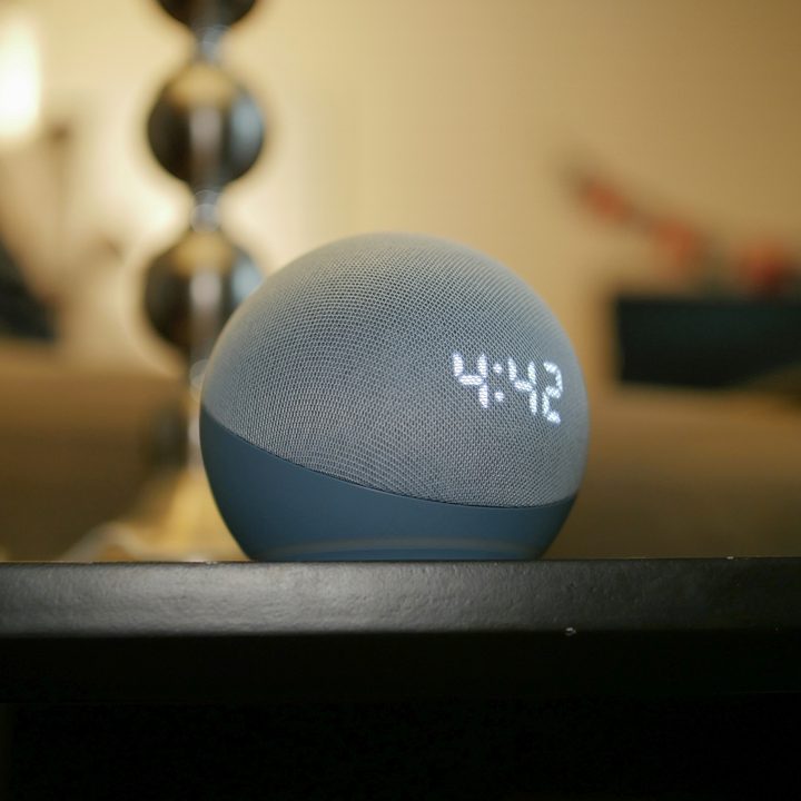 Amazon Echo Dot (4th Gen) with Clock on table.
