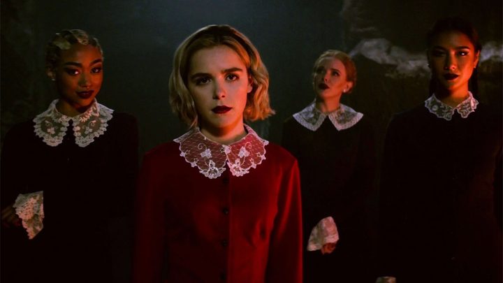 Kiernan Shipka stares into the camera in a scene from Chilling Adventures of Sabrina.