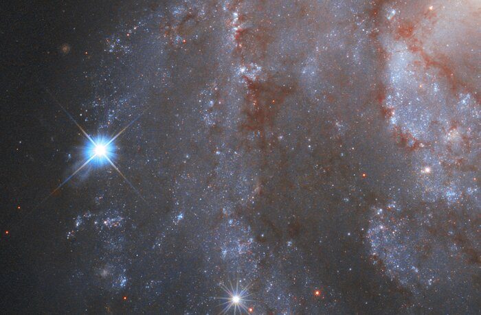 Pictured here is part of the captivating galaxy NGC 2525. Located nearly 70 million light-years from Earth, this galaxy is part of the constellation of Puppis in the southern hemisphere. On the left, a brilliant supernova is clearly visible in the image. The supernova is formally known as SN2018gv and was first spotted in mid-January 2018. Supernovae like this one can be used as cosmic tape measures, allowing astronomers to calculate the distance to their galaxies.