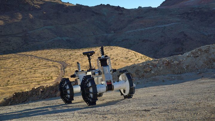 Terrain The DuAxel rover is seen here participating in field tests in the Mojave Desert. The four-wheeled rover is composed of two Axel robots. One part anchors itself in place while the other uses a tether to explore otherwise inaccessible terrain.