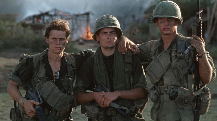 Three soldiers pose for a photo.